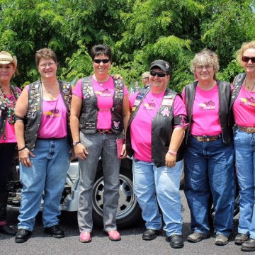 Women Bikers in Pink Posing with Motorcycles at Rally