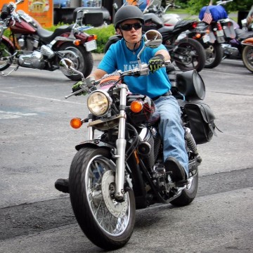 Woman in Blue Shirt on Motorcycle