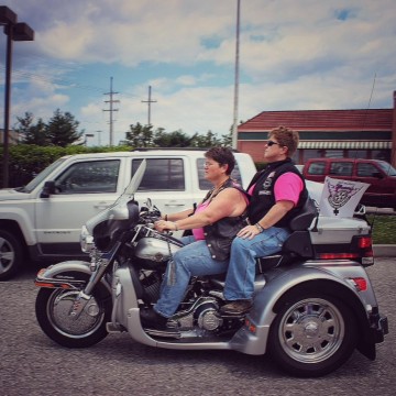 Women Riding Motorcycle at Rally
